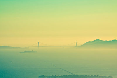 Scenic view of suspension bridge over landscape against sky