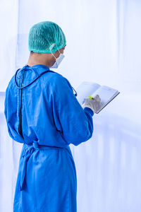 Rear view of person holding umbrella