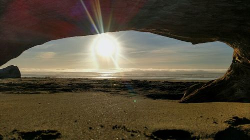 Scenic view of beach against sky during sunset