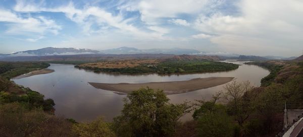 Scenic view of lake against cloudy sky