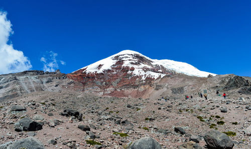 Scenic view of snowcapped mountains against blue sky