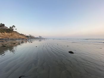 Scenic view of sea against clear sky during sunset