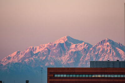 Scenic view of snowcapped mountains against clear sky during winter