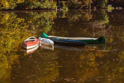 Canoe boats on a foggy lake with autumn foliage and tree reflections. in styria, thal, austria