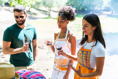 Multiethnic friends having fun a picnic. interracial person hanging out and relaxing. 