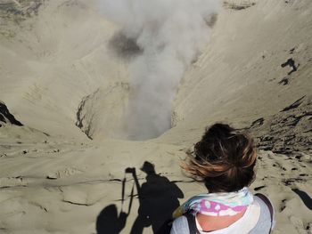 Rear view of woman on snowcapped mountain