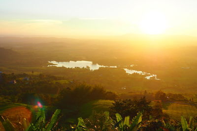 High angle view of plants and landscape against sky during sunset