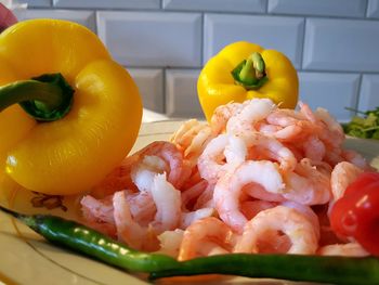 Close-up of bell peppers with prawns and chili peppers in plate