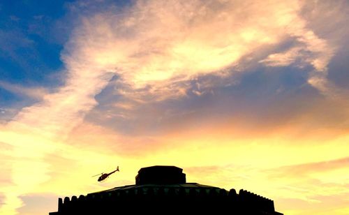 Low angle view of silhouette birds flying in sky