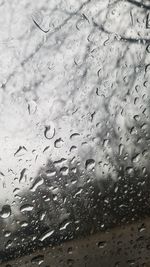 Close-up of water drops on airplane window
