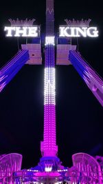 Low angle view of illuminated tower against sky at night