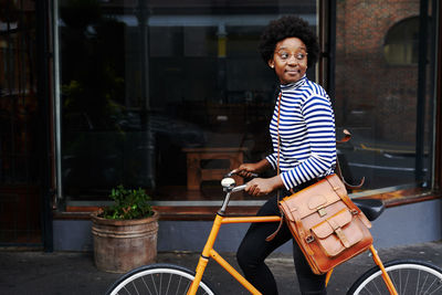 Portrait of woman riding bicycle in city