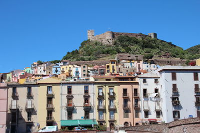 Low angle view of residential buildings against clear blue sky