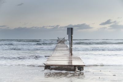 Lifeguard hut on beach against sky