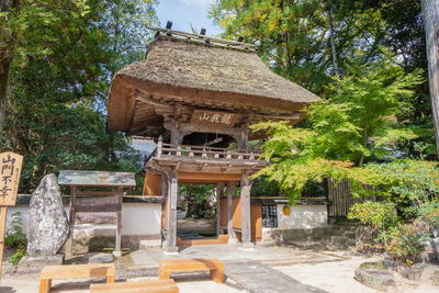 Built structure by trees in forest