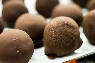 Close-up of chocolate balls with condensate after freezing. homemade candies with small water drops.