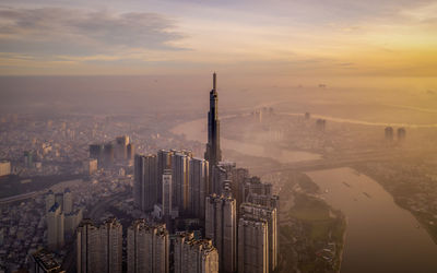 Aerial view of buildings in city during sunset