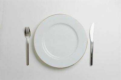 Directly above shot of empty plate against white background