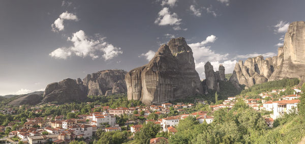 Panoramic view of townscape and mountains against sky