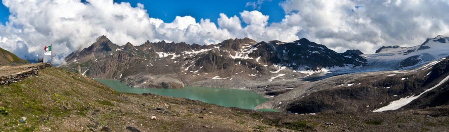 Scenic view of mountains against cloudy sky