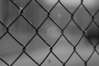 Full frame shot of chainlink fence against sky