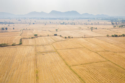 High angle view of cultivated land against mountains
