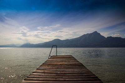 Pier over lake against sky