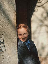 Portrait of smiling girl standing outdoors