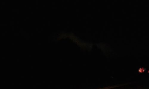 Silhouette of car against sky at night