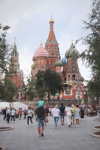 Group of people in front of building against sky