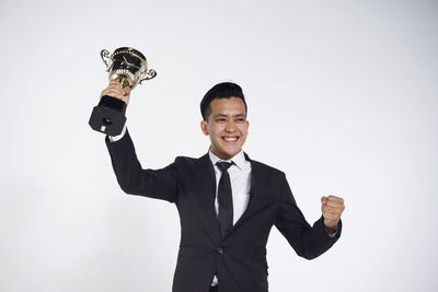 Portrait of a smiling young man against white background