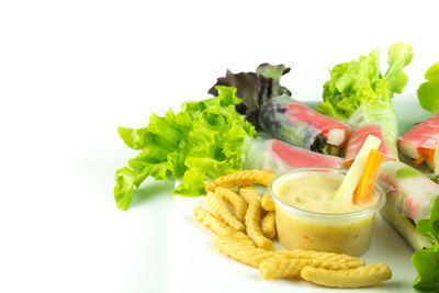 Close-up of served food in bowl against white background