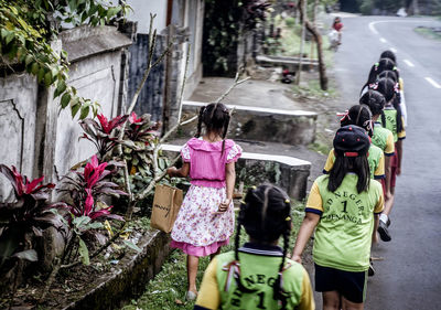 Elevated view of girls walking on road