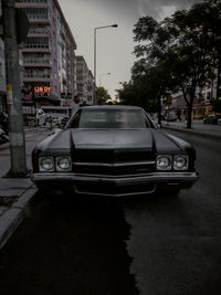 Car on street against buildings in city