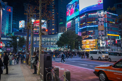 People walking on road in city at night