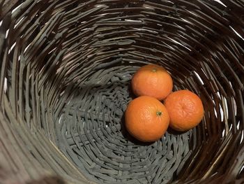 High angle view of orange fruits in basket