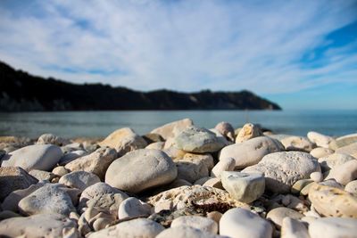 Rocks on beach against sky