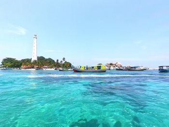 Scenic view of sea by buildings against clear sky