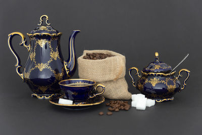 Close-up of tea cup on table against black background