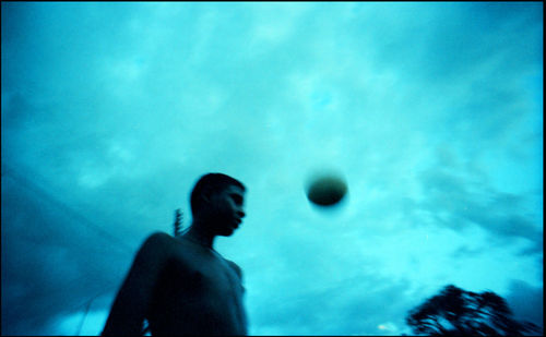 Silhouette man swimming in pool