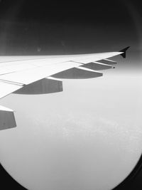 Airplane wing against sky