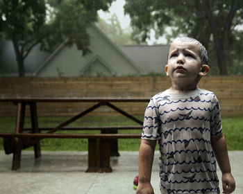 Portrait of young woman standing in park