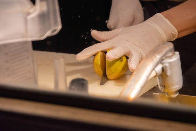 Midsection of man preparing food in kitchen