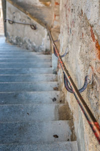 Close-up of staircase by wall