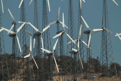 Low angle view of cranes against clear sky