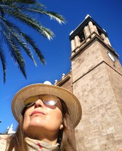 Low angle view of woman standing against sky