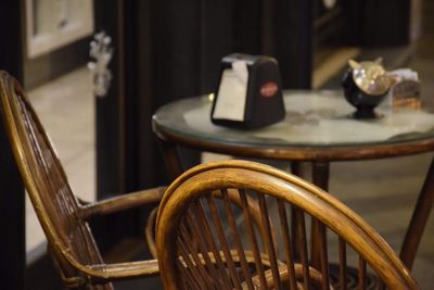 Close-up of chairs on table