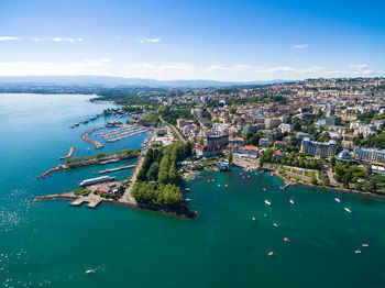 High angle view of city by sea against sky