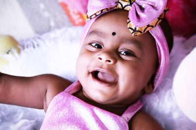 Close-up of baby on bed