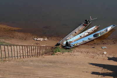 High angle view of abandoned boats moored on beach